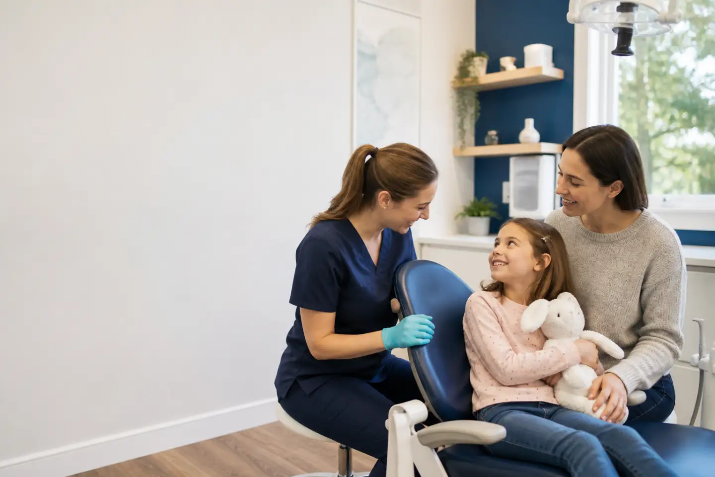 Young child enjoying a welcoming first dental appointment with a parent nearby
