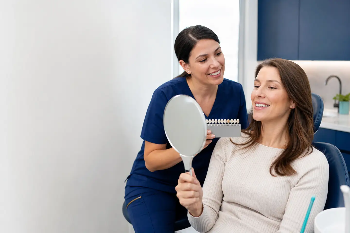 Patient and dentist discussing natural-looking dental veneers
