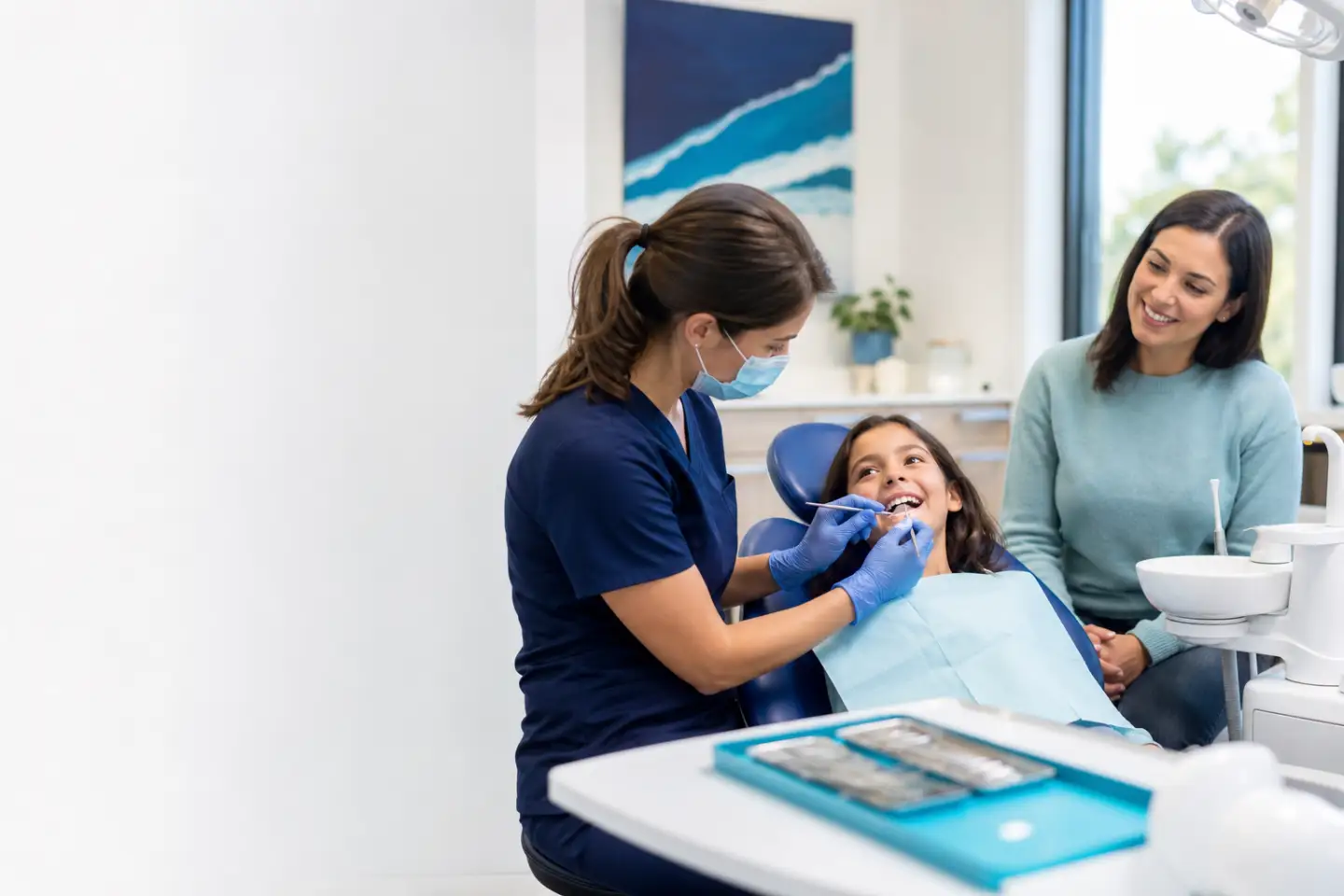 Dental hygienist providing a gentle teeth cleaning for a child